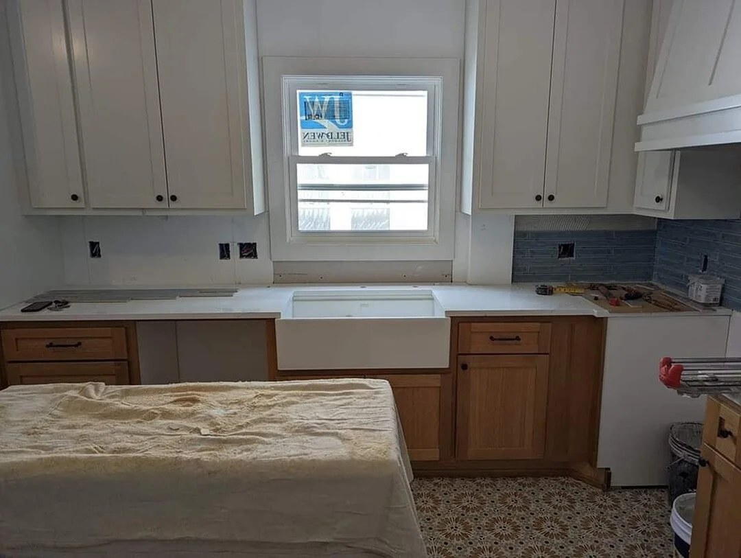 A finished kitchen with light cabinets and a stone countertop in Edina, Minnesota